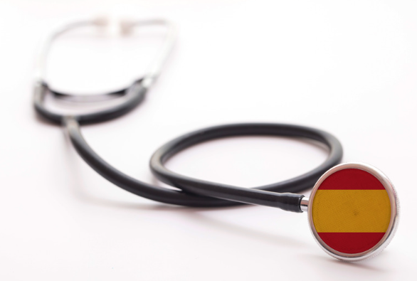Does Spanish public healthcare system cover pre-existing conditions?