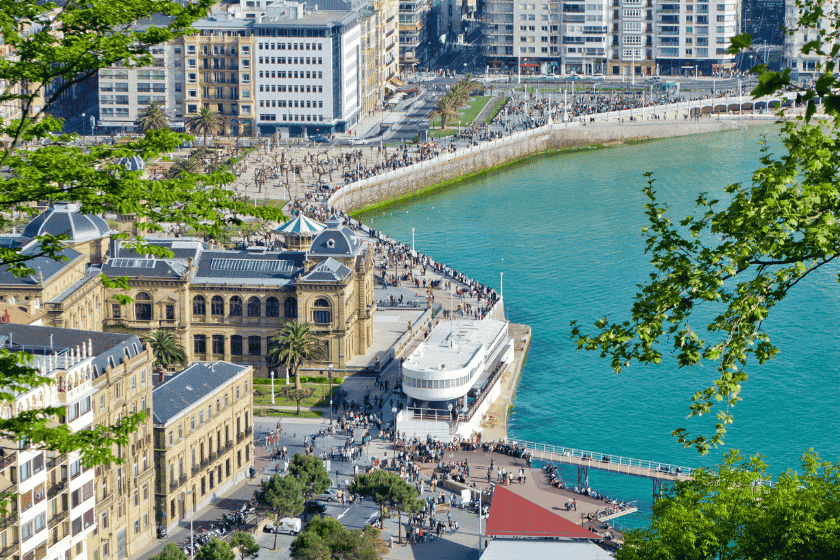 A collage of San Sebastián's culture: a chef preparing intricate pintxos, surfers at Zurriola beach, and the international film festival sign