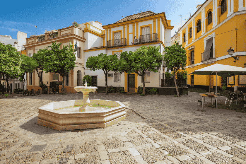 A charming, narrow street in the Santa Cruz neighborhood and a view of the Guadalquivir River