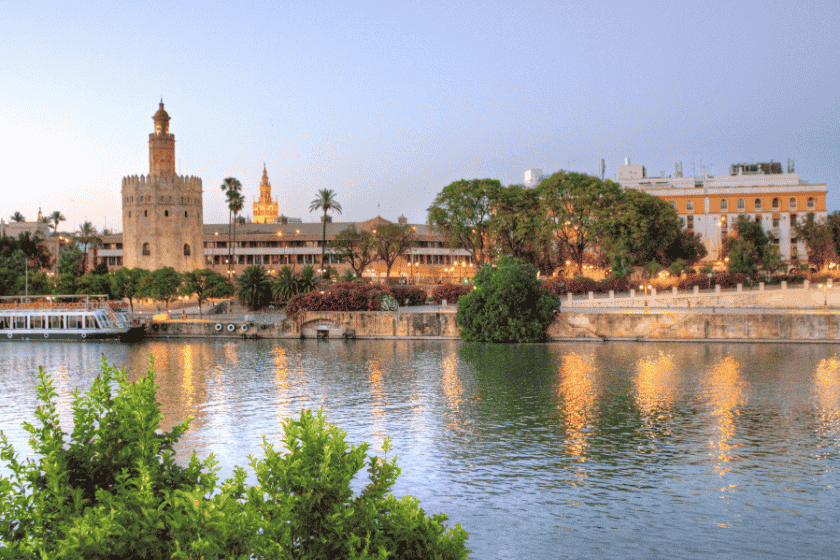 A collage of Seville's culture: a flamenco dancer, the Giralda tower, and colorful Feria dresses